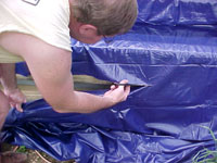Trim the excess liner, roll to attach to the top timber